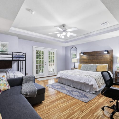 Primary bedroom with a king size bed, 2 twin size beds (bunk bed), and a full size sofa bed!