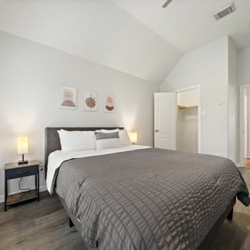 3rd bedroom with a queen-size bed and a dedicated workspace.
