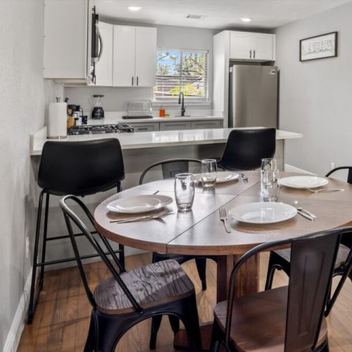 Dining table is conveniently close to the kitchen.