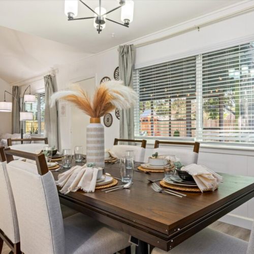 Spacious dining table that sits 6 with full tableware and silverware included.