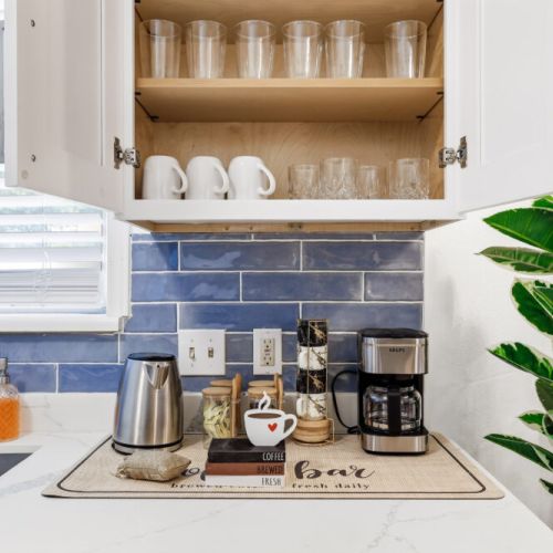 Drip coffee machine with complimentary coffee, decaf, tea, sugar, cream, and sweetener