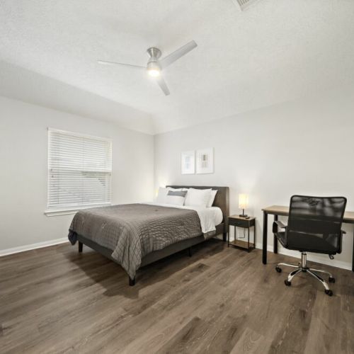 2nd bedroom with a queen-size bed and a dedicated workspace.