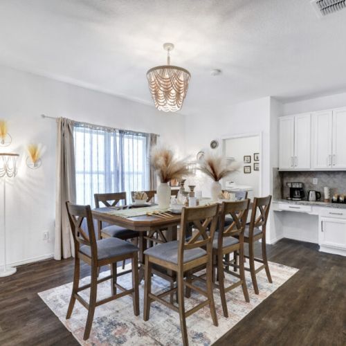 Spacious dining table that sits 8 with full tableware and silverware included.
