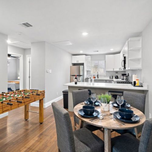 Spacious dining table with full tableware and silverware included.