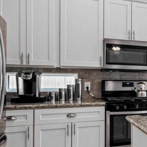 2 Keurig coffee machines with complimentary coffee pods, tea, sugar, and cream.