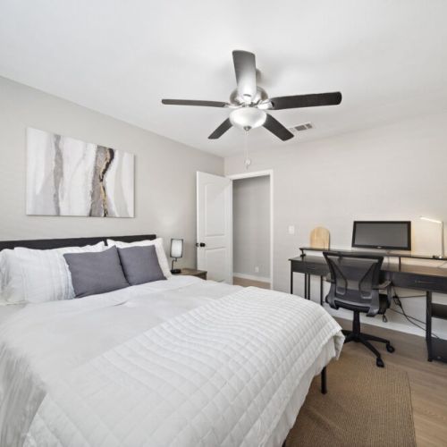 2nd bedroom with queen size bed with it's own dedicated workspace.