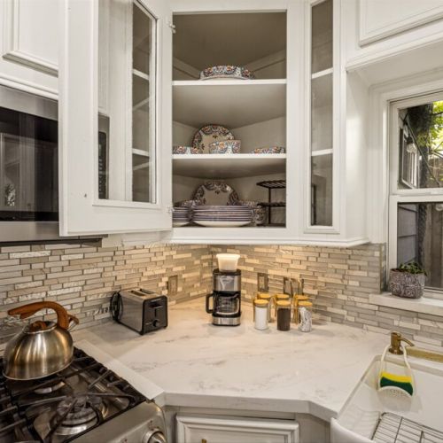 Drip coffee machine with complimentary coffee,  decaf, tea, sugar, cream, and sweetener.