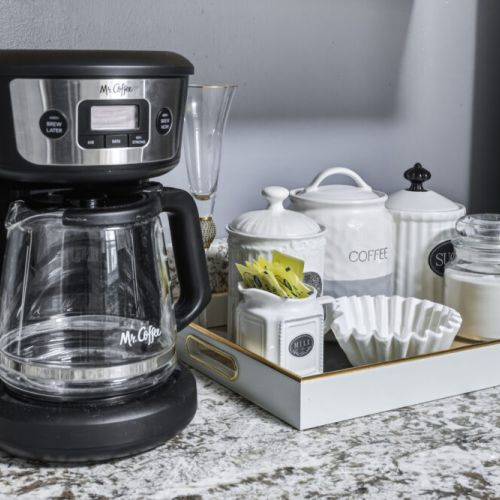 Coffee bar included with a drip coffee machine with complimentary coffee, tea, sugar, cream, and sweetener