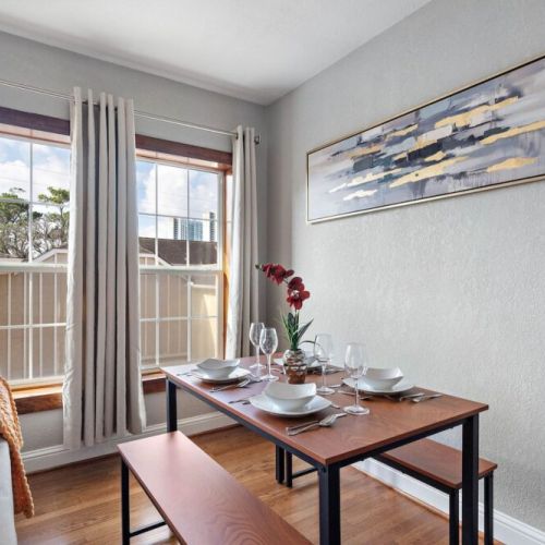 Spacious dining table that sits 4 with full tableware and silverware included