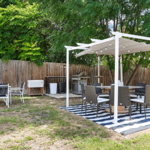 Grill, outdoor seating, and cooler.