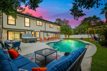 Whether you're cooling off in the pool or relaxing in the hot tub, this backyard is made for unwinding.