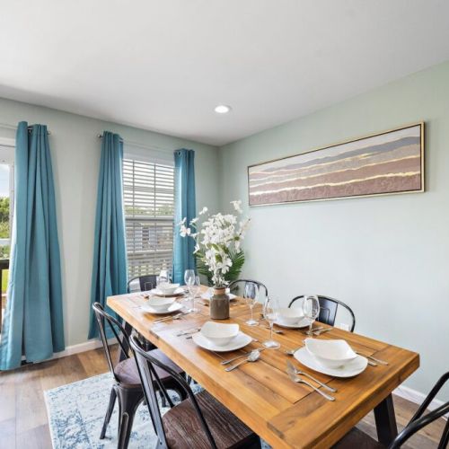 Spacious dining table that sits 6 with full tableware and silverware included.