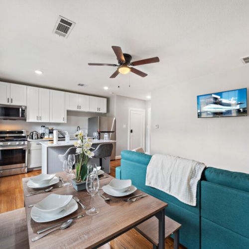 Spacious dining table that sits 4 with full tableware and silverware included.