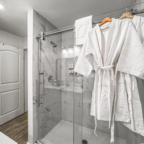 With luxury walk-in shower. White robes included.