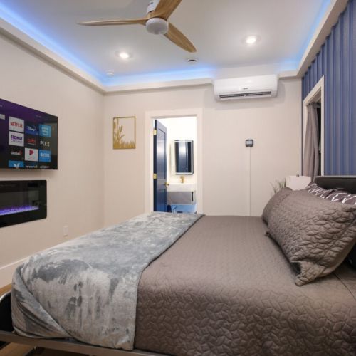 5th bedroom with king size bed, smart tv, and electric fireplace