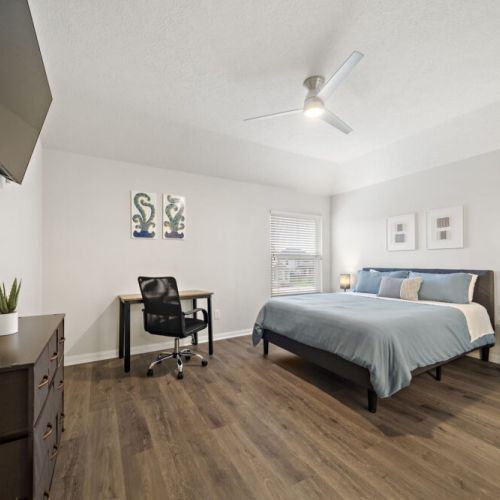 4th bedroom with a queen-size bed and a dedicated workspace.