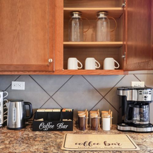 2-Way drip coffee machine with complimentary coffee,  decaf, tea, sugar, cream, and sweetener.