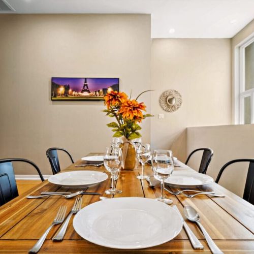 Spacious dining table that sits 6 with full tableware and silverware included.