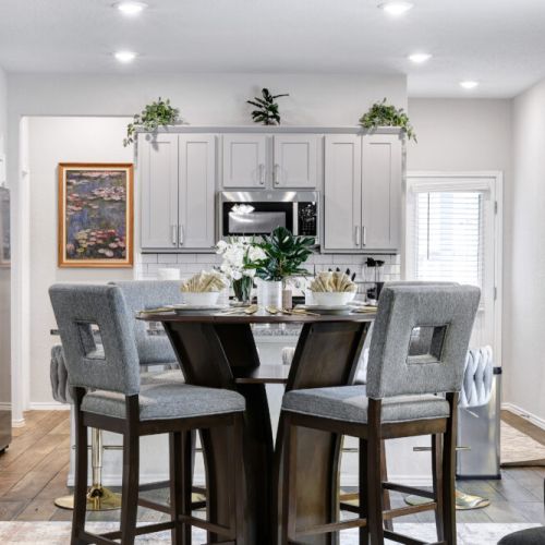 Spacious dining table that sits 4 with full tableware and silverware included.