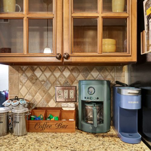 Keurig coffee machine + drip coffee machine with complimentary coffee, coffee pods, tea, sugar, cream, and sweetener.