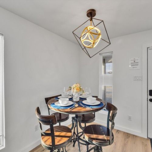 Charming dining table that sits 4 with full tableware and silverware included.