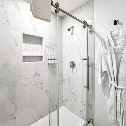 With luxury walk-in shower. White robes included.
