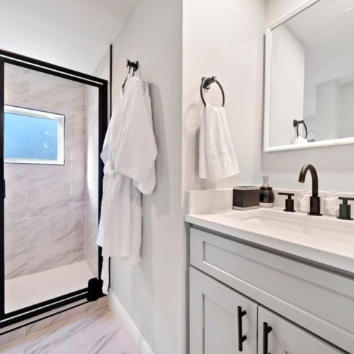 Bathroom  is fully stocked with all you need. Makeup pads, q-tips, and white robes included.