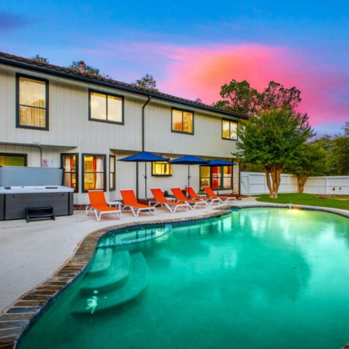 A resort-style backyard with a pool, hot tub, fire pit, mini golf, and plenty of space for outdoor fun.