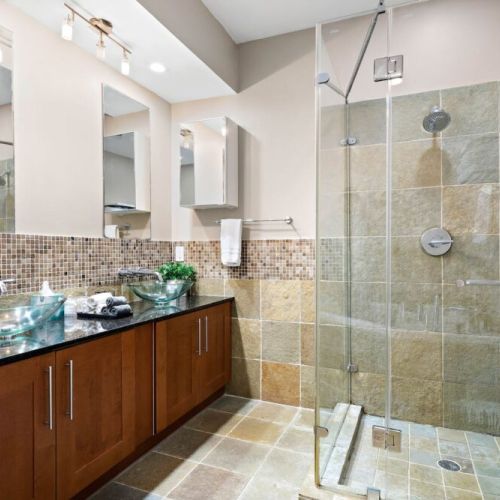 Primary bathroom with dual sinks, makeup pads, and q-tips.