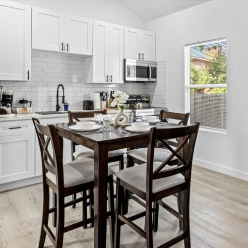 Charming dining table that sits 4 with full tableware and silverware included.