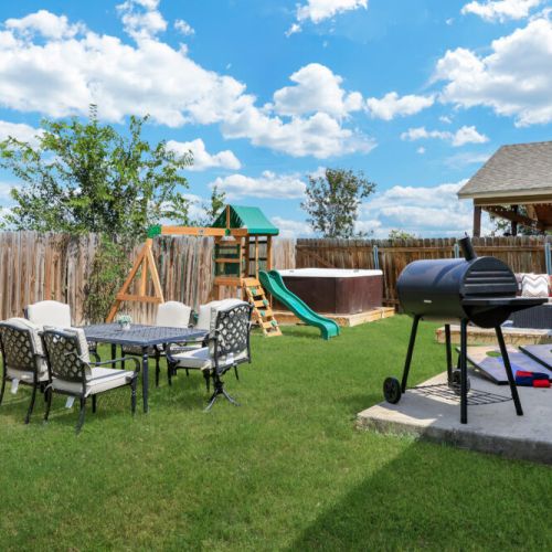 Savor the joy of cooking alfresco with our charcoal grill, creating delicious meals while enjoying quality moments with your family and friends in our amazing hot tub. Plus, we include a cornhole set!