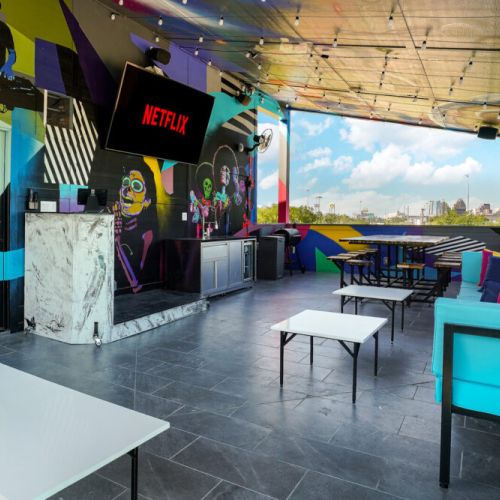 Rooftop deck with murals, lighting, and sound system.