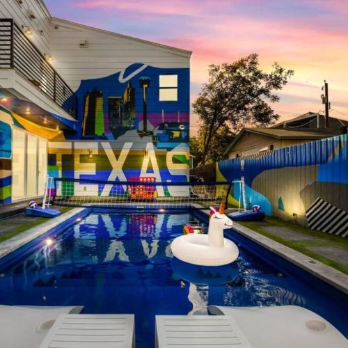 Pool area surrounded by amazing murals.