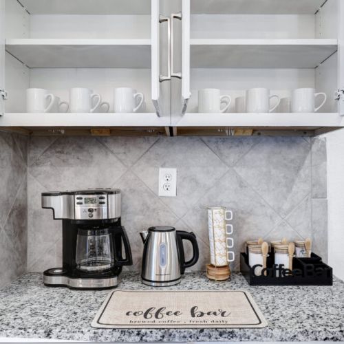 2-Way drip coffee machine with complimentary coffee, tea, sugar, and cream