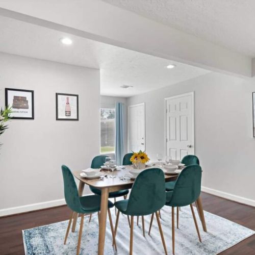 Spacious dining table that sits 6 with full tableware and silverware included.