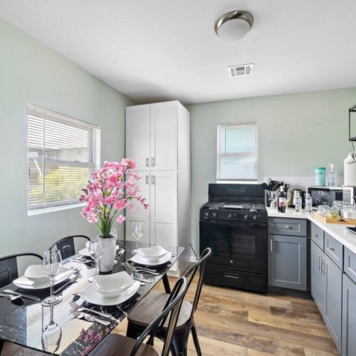 Spacious dining table that sits 4 with full tableware and silverware included.