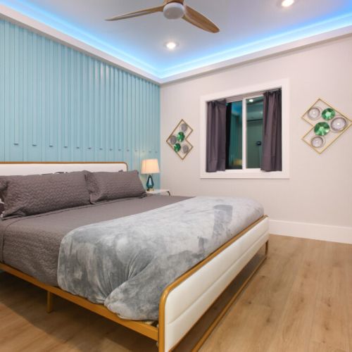 4th bedroom with king size bed, smart tv, desk and electric fireplace