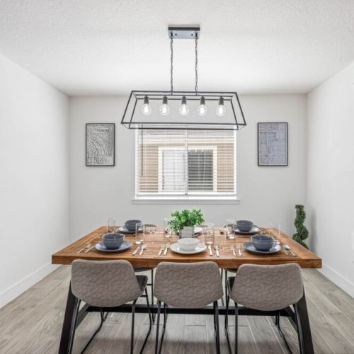 Spacious dining table that sits 6 with full tableware and silverware included.