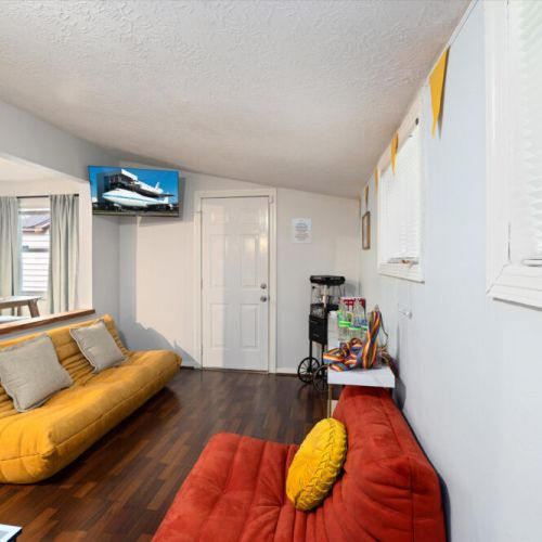 Game room with lazy floor sofas and smart TV.