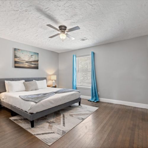 Primary bedroom with 1 king size bed! TVs are included in all bedrooms.