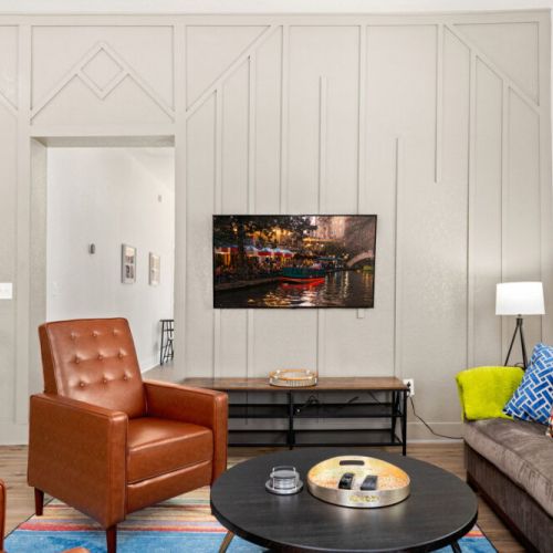 Luminous living room with beautiful wall art and chic furnishings.