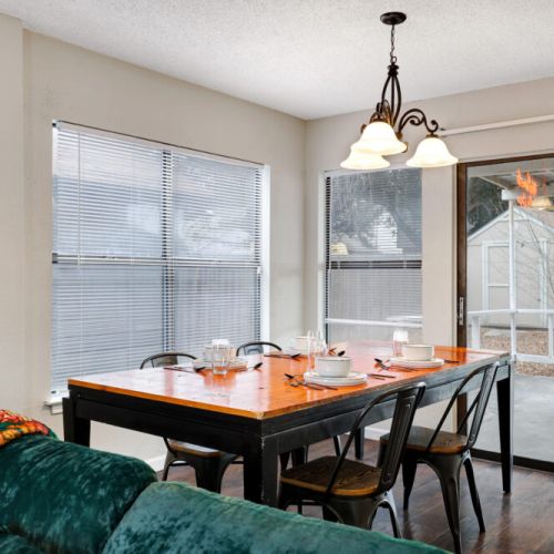Spacious dining table that sits 4 with full tableware and silverware included.