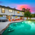 A resort-style backyard with a pool, hot tub, fire pit, mini golf, and plenty of space for outdoor fun.