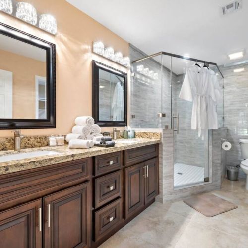 Primary bathroom with dual sinks, makeup pads, and q-tips.