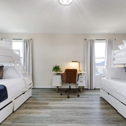 5th bedroom with 2 twin and 2 full sized beds (2 bunk beds). Dedicated workspace included.