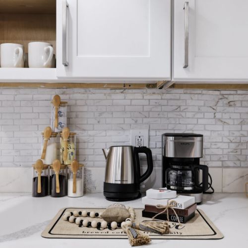 Drip coffee machine with complimentary coffee, decaf, tea, sugar, cream, and sweetener